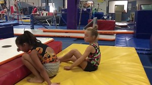 July 18, 2019 Alina and Lila working on feeling their correct body shape and leg tightness during back extension roll. Drilled on elevated mat from seated position. | Gymnastics World