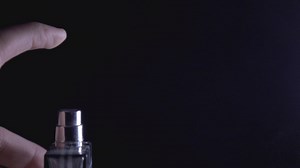 Spraying Perfume On Black Background | Premium Stock Video Footage