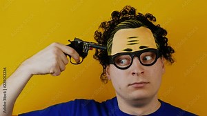 comical man with toy pistol handgun shoots himself in the head for fun