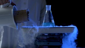 Bottle and liquid nitrogen in a laboratory. Chemical experiment. Flask with water and dry ice boiling chemical experiment