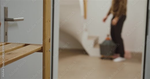 A man moves a heavy object using a rolling platform instead of carrying it. Concept of ergonomics, back protection, safer lifting alternatives, and smart handling in everyday life.