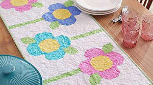 2.9K views · 36 reactions | Bring some spring flowers inside with an easy-to-piece modern table runner. Join our Quilts & More sew-along to make this pattern -- we have lots of fun planned! Details here: https://www.allpeoplequilt.com/quiltalong/front-runner-sew-along | American Patchwork & Quilting | Facebook