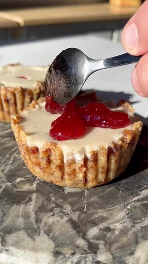 Cheesecake, but make it vegan! Our recipe is very easy to make and only takes 30 minutes. (Social Media Manager note: This is the best vegan dessert I’ve ever had!) INGREDIENTS 1 cup walnuts ½ cup dates 1 cup raw cashews, soaked in hot water 1 large lemon, zested and juiced 2 oz Treeline® Dairy-Free Sour Cream [2 oz; 1 each] ¾ cup coconut cream ½ cup agave nectar 2 tbsp strawberry preserves ½ tsp salt 2 tbsp vegetable oil Cooking spray DIRECTIONS Step 1. Make the crust Line two of the muffin for