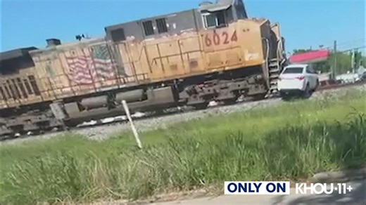 Video captures train slam into car in SE Houston, push it down the tracks