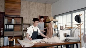4K 50fps, Young LGBTQ Asian Men Small Business Partner The assistant asks what parts of the set he has made and what parts he needs to modify.Professional Design clothes to sell online.