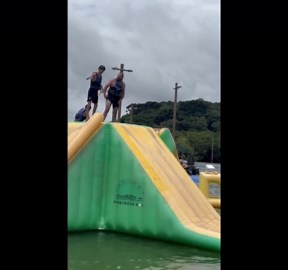 Excited rider slips before inflatable water slide in Campo Largo, Paraná, Brazil