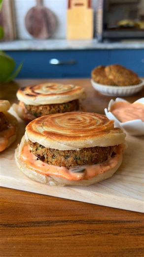 Nikita Varma Chef/Foodblogger on Instagram: "✨ Viral Dubai Lachha Paratha Burger – Veggie Style! ✨ This trending street-style burger just got a desi vegetarian twist 🤩 I’ve made it using my homemade chana kebab – super soft, melt-in-mouth, and loaded with protein 🌱💪. The crispy, flaky lachha paratha acts as the bun, adding that perfect crunch and desi touch 🫓🔥. Paired with a creamy sauce, every bite is indulgent yet wholesome – a perfect balance of flavor and texture. 🥙💛 Yes, it’s a sligh