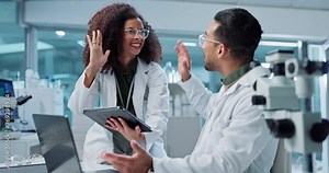 Science, teamwork and high five with laptop in laboratory for test breakthrough, pharmaceutical review or excited. Scientist, collaboration or technology for research, discussion and digital analysis