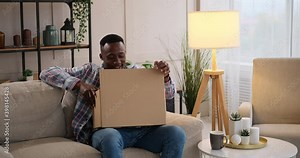 Man frustrated on unpacking a wrong package delivered from an online store