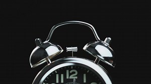 Alarm clock activated close up on a black background - Free Stock Video