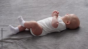 Newborn baby is crying, lying on bed, spitting out pacifier. Cute baby is tired, hungry, suffering from colic, crying, feeling dangerous and lonely. Baby cry. Concept of infancy, care Stock Video