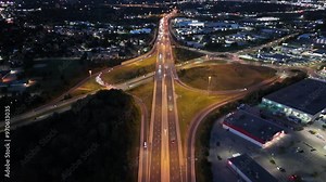 Aerial footage of the Highway 85 with illuminated buildings of Waterloo at dusk in Ontario, Canada