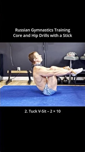 Russian gymnastics training for core strength, hip mobility, flexibility using a stick.