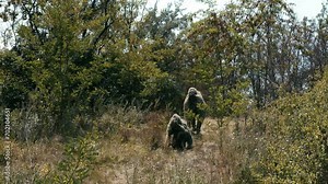 Special forces soldiers, snipers in camouflage clothes on anti-terrorist operation ready to shoot from sniper rifles, shooting at the enemy. Footage of military operations. War concept