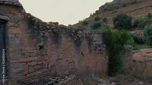Old ancient ruins of abandoned buildings in Algeria, Tlemcen, hills and mountains in background