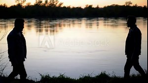 Two men stand back to back