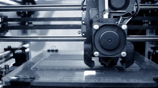 3D printer printing object. 3D printer printing an object from molten plastic on a work surface of 3D printer. 3D printer creating a model. Molten plastic flowing out of an extruder close-up