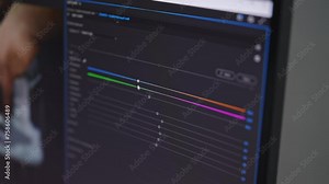 Closeup of unrecognizable professional photographer working in photo editing app software on desktop computer. Video editor retouching footages from creative home office. Shooting in slow motion.