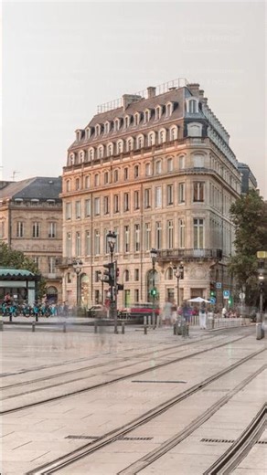 Triangular building and modern tram at Place de la Comedie timelapse, Bordeaux, France