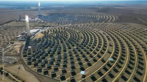 Aerial view of the Solar Power Towers PS10 and PS20 in Sanlúcar la Mayor, Seville. Spain's stunning solar energy plant. Concentrated solar power plant. Renewable energy. Green energy.