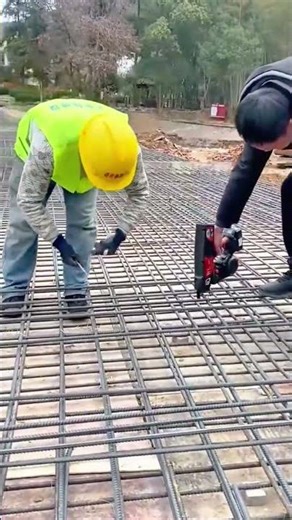 fastening steel bars with a handheld rebar tier and wire to create a strong reinforced foundation