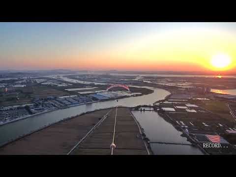 Drone-Towed Paraglider Rising into the Sunset