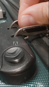 Vertical video. A Hand demonstrates how to use the combination lock, adjusting the code to unlock the zipper pulls on the suitcase. Stock Video