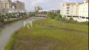 Aerial flying over tidal marsh in north myrtle beach with views of resorts and homes.