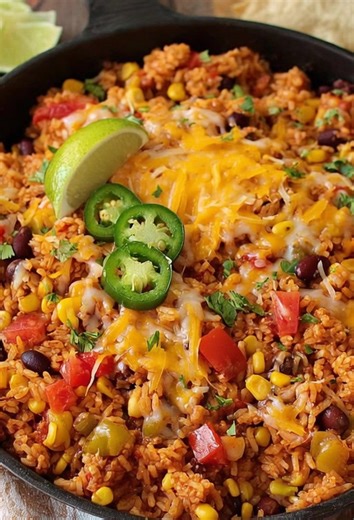 🌮🧀 Cheesy Mexican Rice Skillet Bold, Cozy & One-Pan Easy 💛 This Cheesy Mexican Rice Skillet is loaded with fluffy seasoned rice, black beans, sweet corn, and colorful peppers, all finished with melty cheese, fresh lime, and a little heat. It’s fast, filling, and packed with bold Tex-Mex flavor—perfect as a cozy one-pan dinner or an easy side for tacos, chicken, or grilled meats. Ingredients • 1 1/2 cups long-grain white rice, uncooked • 2 1/2 cups chicken or vegetable broth • 1 tablespoon oli
