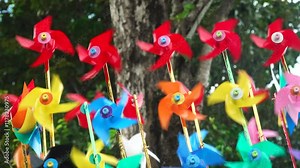 Colorful paper windmills spinning in the wind. Focus selected