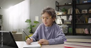 Cute kid girl talking to webcam learning online, conference call video chat with tutor on digital tablet. Online learning class. Remote children education