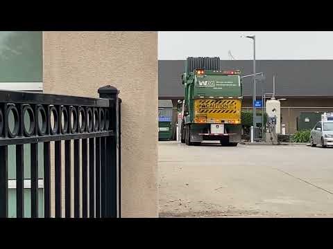 Garbage truck wm picking up