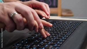 Closeup of mother teaching little son typing and using laptop keyboard. Parent and child typing and pressing buttons on laptop keyboard
