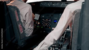 pilots in the cockpit of the plane near the control panel with a tablet in their hands discuss the route before the start of the flight simulator