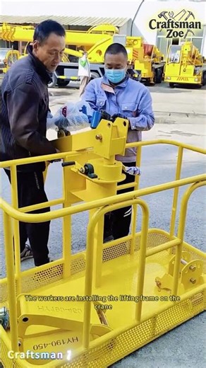 The workers are installing the lifting frame on the crane