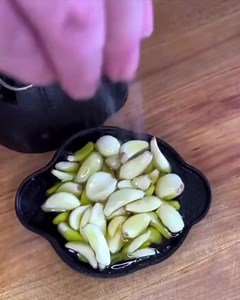 🧄 This cast iron tool lets you get perfect roast garlic just right, in the oven or on the grill. | Uncommon Goods