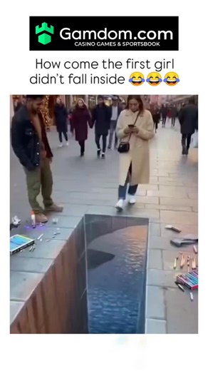 Briefly Explaining on Instagram: "The post shares a 10-second video of a 3D street art illusion simulating a water-filled hole on a busy sidewalk, where two women react with surprise after seemingly falling in, revealing it's a chalk-drawn optical trick. - Garnering over 9 million views and 6,600 likes in hours, it sparks debates in replies about authenticity, with some dismissing it as AI-generated despite evidence of similar real-world installations by artists like Edgar Müller. - This illusio