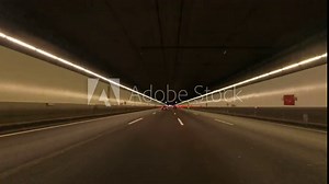 Time Lapse: Car point of view POV on a sunny day driving through the four-lane tunnel M30 from Portugal Avenue to Spain Square with buses, taxis and cars circulating. POV driving a car in Madrid