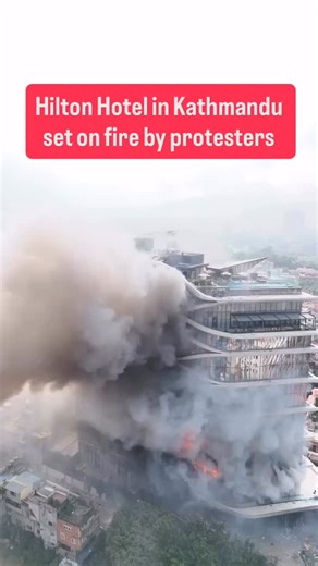 The Asian Chronicle on Instagram: "Shocking visuals from Kathmandu show the Hilton Hotel engulfed in flames after being set ablaze during deadly Gen Z protests. The luxury five-star property was reduced to a charred shell, with burnt windows, smoke stains, and severe structural damage. The violent unrest continues to escalate as protesters target symbols of wealth and power in the capital. #Nepal #Kathmandu #HiltonHotel #GenZProtest #BreakingNews #NepalProtests #NepalUnrest #KathmanduUnrest #Sou