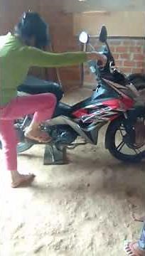 woman cranking motorcycle kickstart moped pedal pumping girl kickstarting