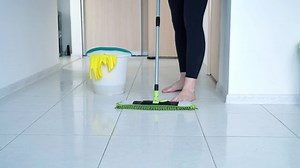 clip-1052935052-woman-washing-white-kitchen-floor-special-swob