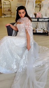 Need some extra drama to your wedding day look: enter the Bridal CAPE! We love styling this square neck wedding dress with a detailed cape to take it to the next level! Would you wear a cape with your bridal gown? #neworleans #bride #weddingdress #cape | The Bridal Boutique by MaeMe | Facebook