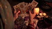 Close-up of a fortune teller reading tarot cards