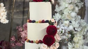 beautiful wedding cake decorated with red flowers