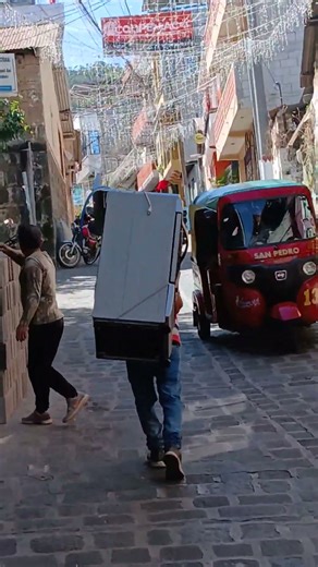 carrying a stove on his back Guatemalan man