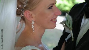 Groom kissing his lovely bride on her cheek on their wedding day