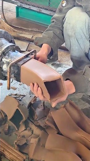 Guiding extruded clay into rectangular hollow shape from machine mold