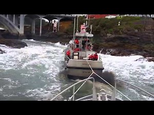 Coast Guard Station Depoe Bay lifeboat tows another lifeboat through "The Hole"