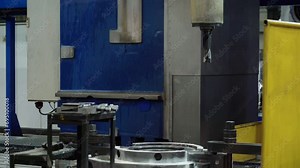 Automated industrial drilling machine at Turbine Production Factory. An industrial drilling machine is Slowly moving downwards. An industrial drilling machine is prepared for Operation. Manufacturing.