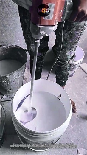 Electric paddle paint mixer tool: smooth blends concentrated purple pigment into white wall paint